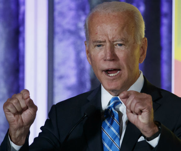 joe biden balls up his fists as he speaks in washington