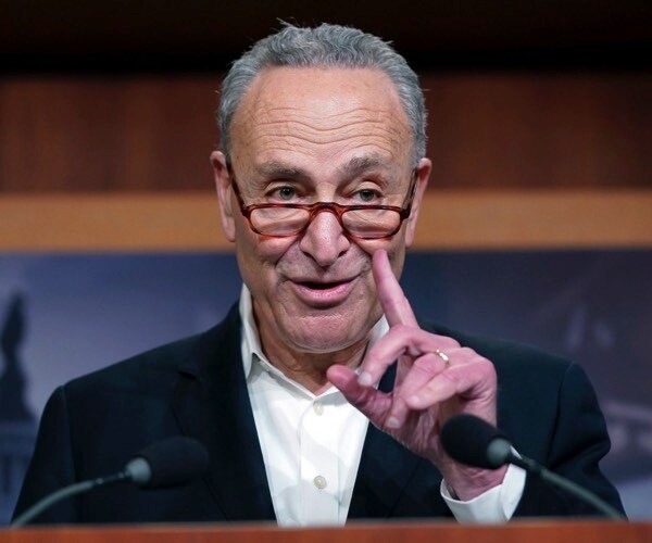 senate minority leader chuck schumer of n.y., gestures while speaking to members of the media at the capitol.