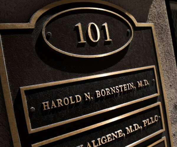 bornstein's nameplate is shown outside of his nyc office