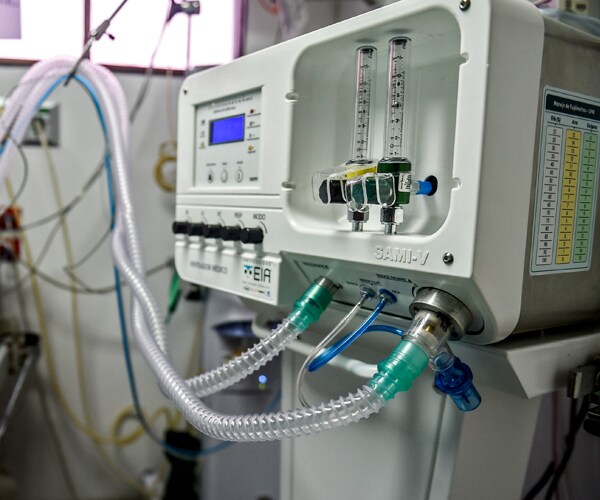 tubes hooked up to a ventilator in a hospital room