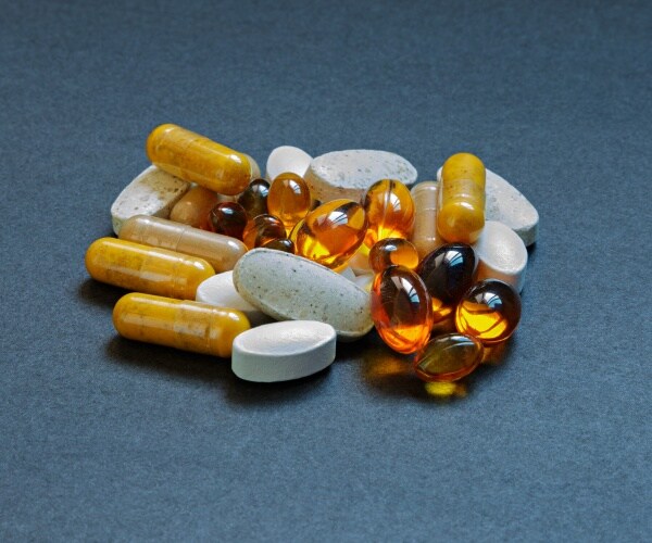 a variety of vitamin and mineral supplements together on surface