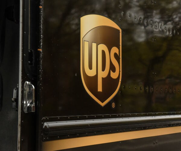 the ups logo is shown on the side of one of its delivery trucks