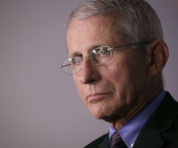 dr. fauci is seen in a dark suit, dress shirt and tie