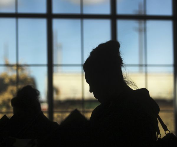 a person is silhouetted at the david r. romero south cheyenne community park building in wyoming while voting.