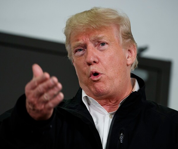 president donald trump gestures with his right hand's four fingers forward while delivering remarks to reporters