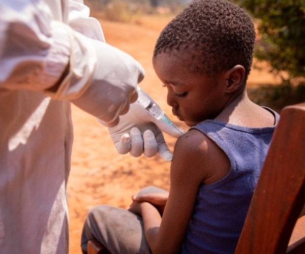 boy receiving vaccine in Africa