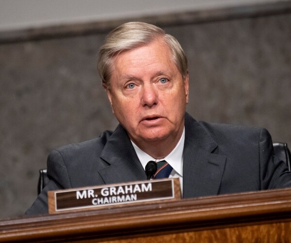 lindsey graham speaks during a judiciary committee meeting in a dark gray suit and striped tie