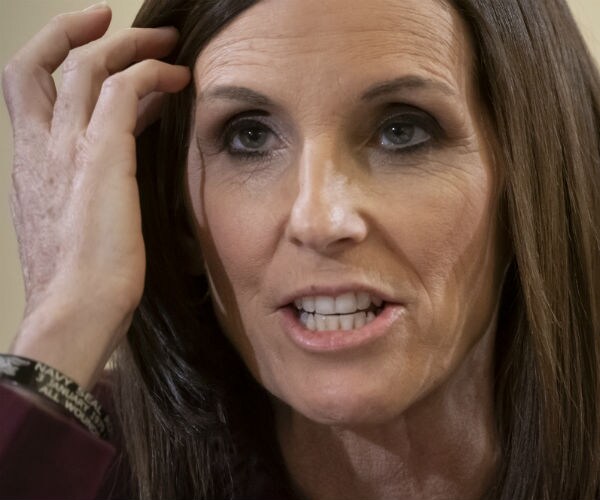 Sen. Martha McSally is shown pushing her hair out of her face.