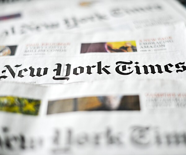 a stack of the new york times newspapers lay on a table