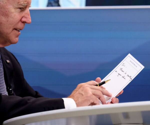 Biden Handed Card in Meeting Saying Something on His Chin