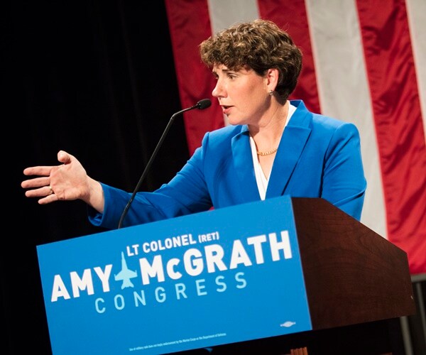 amy mcrath speaks at an event from a podium