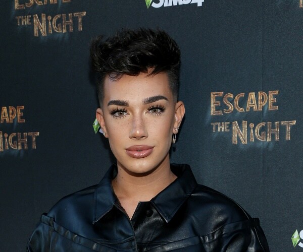 james charles stands on red carpet