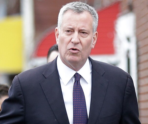 bill de blasio speaks as he walks down the streets of new york city