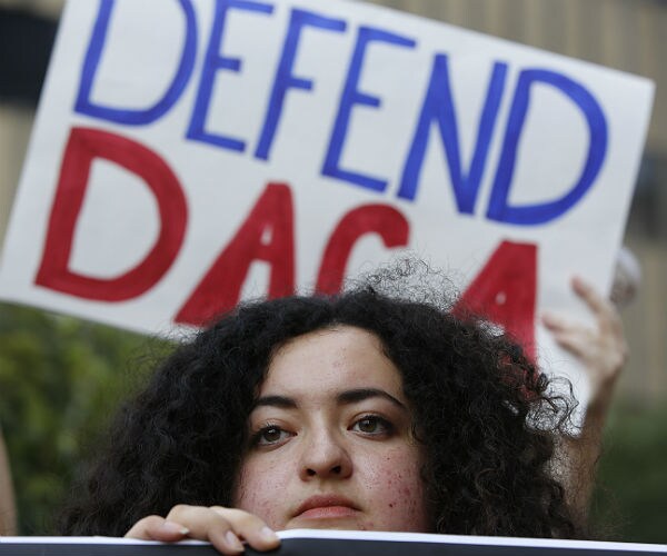 supporters of daca hold signs