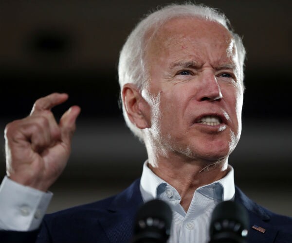 joe biden is shown making a point while speaking 