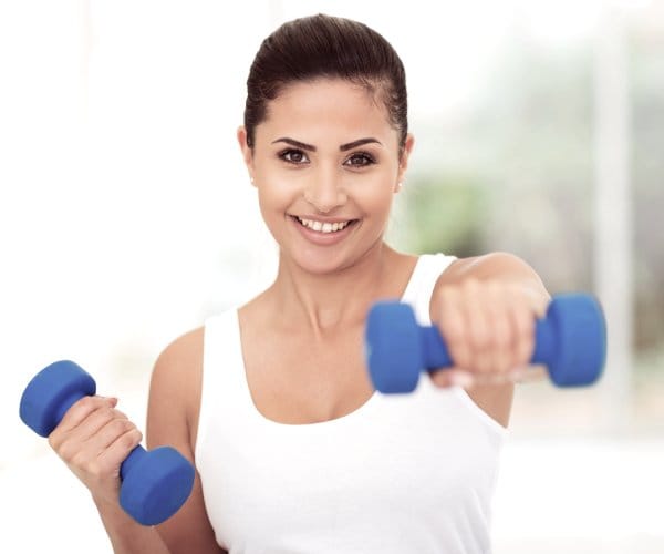 Woman working out with dumbbells. 