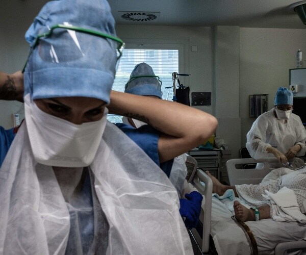 Nurses and doctors work in a COVID-19 intensive care unit