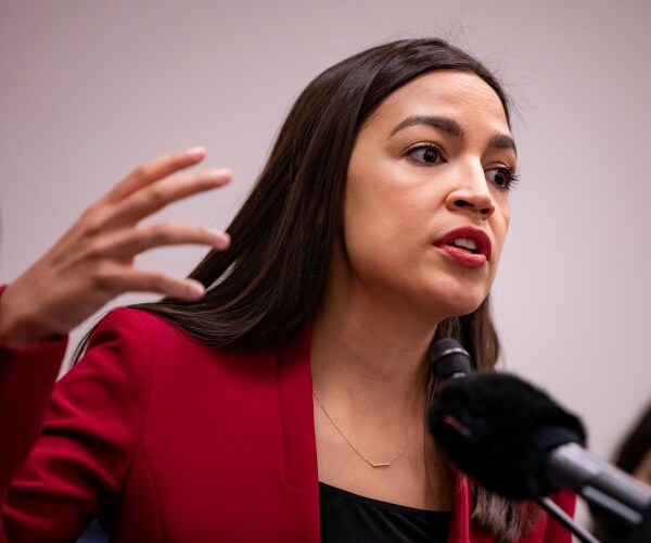 aoc in a red blazer and black top