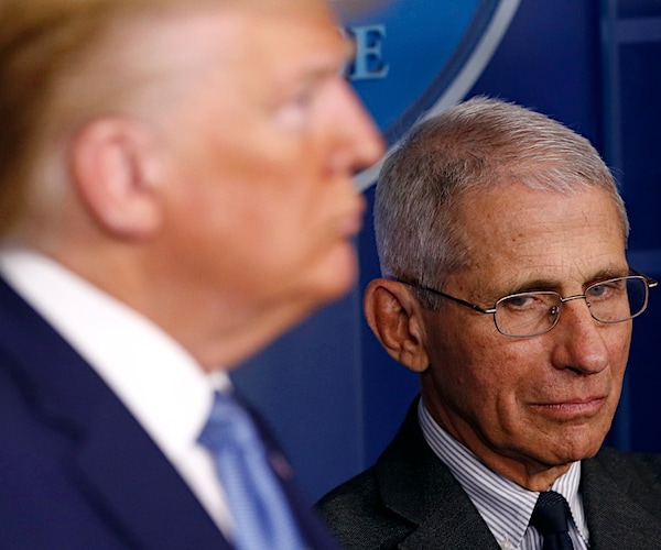 doctor anthony fauci casts a skeptical eye at president donald trump during a coronavirus task force briefing