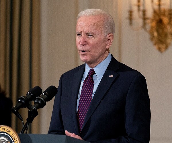 joe biden speaks into microphone