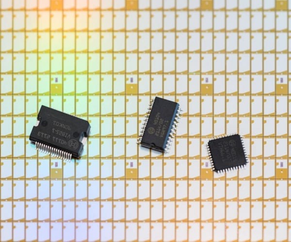 300 millimeter wafer with semiconductor chips on background of yellow and white