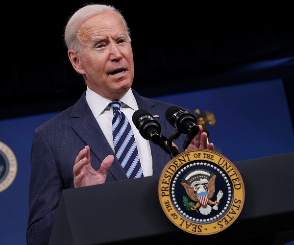 joe biden speaks into podium mic