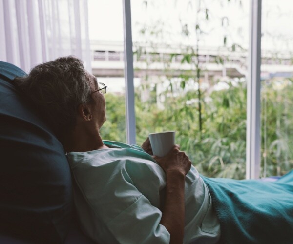 a man in a hospital bed 