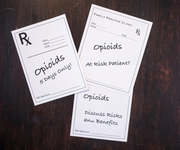 3 prescriptions pads with notes about opioid addiction, limited prescriptions