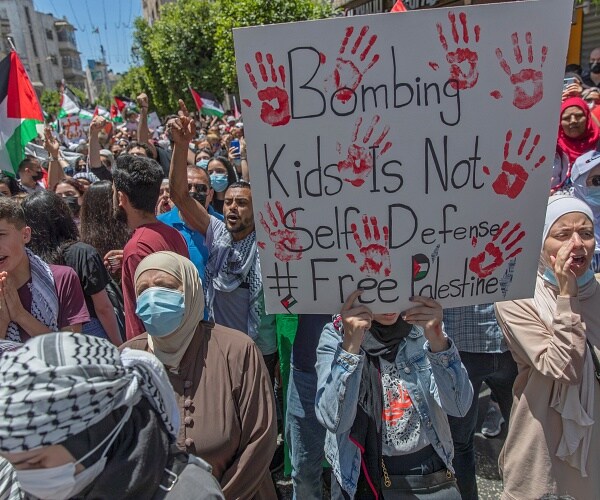 palestinians carry signs during protest