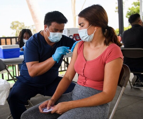 A California State University Long Beach student receives a dose of the Pfizer COVID-19 vaccine.