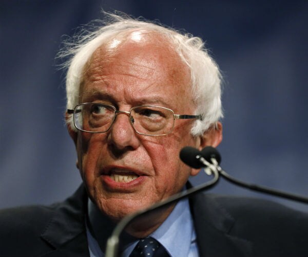 Sen. Bernie Sanders looks to his right as he speaks at a podium on the campaign trail.