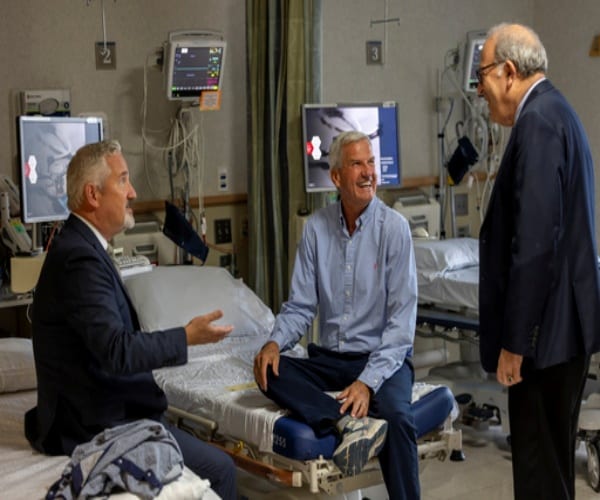 Michael Garrity in hospital talking to his doctors about the renal denervation procedure to lower blood pressure