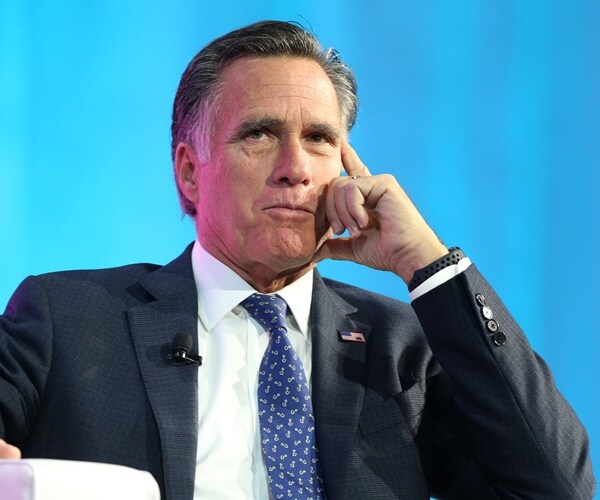 mitt romney speaks on a panel