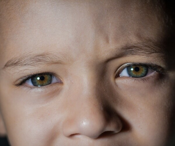 close-up photo of young boy's green eyes