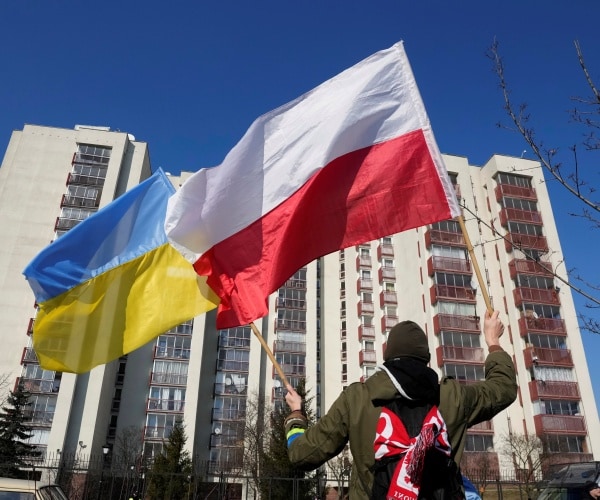 A man waves the Ukrainian and Polish flag during a demonstration