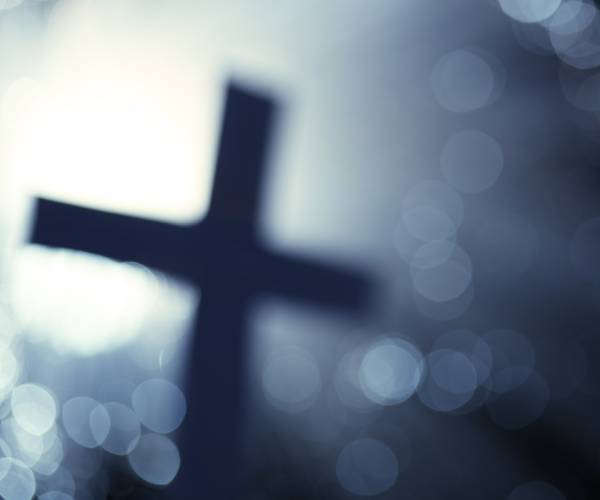 a cross with light in the background