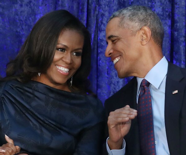 michelle and barack obama sharing a laugh