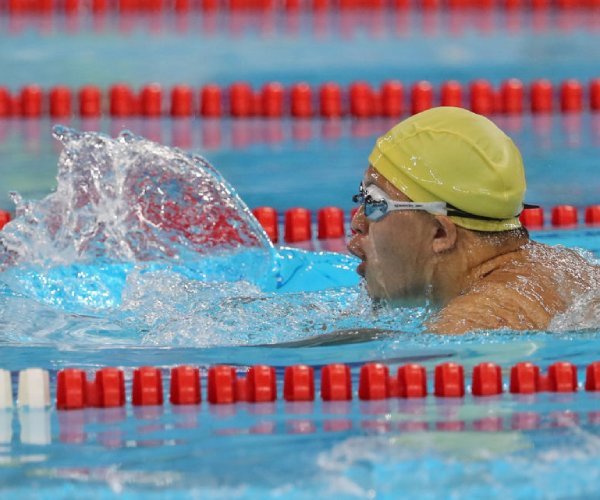 a special olympics swimmer competes in an event