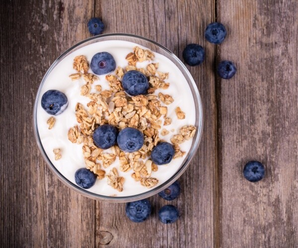 bowl of yogurt with some oatmeal, fruit on top