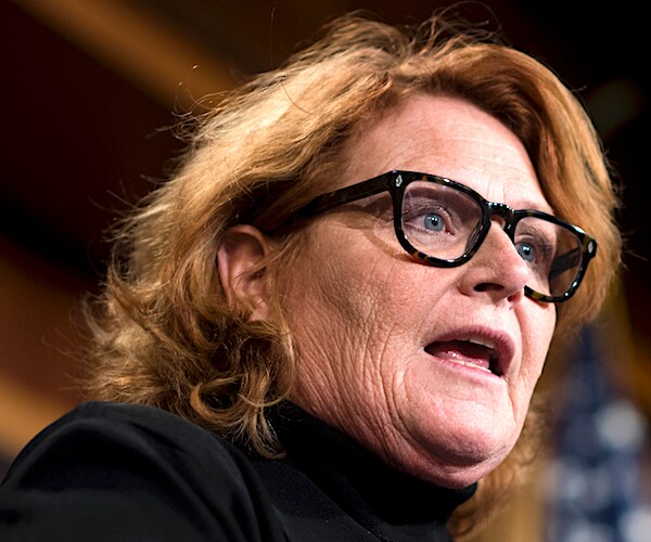 north dakota senator heidi heitkamp, wearing glasses, delivers remarks