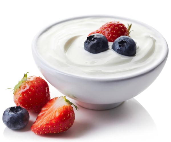 a bowl of greek yogurt with blueberries and strawberries