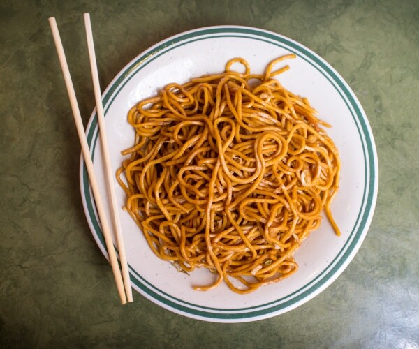 lo mein noodles on white plate, chopsticks