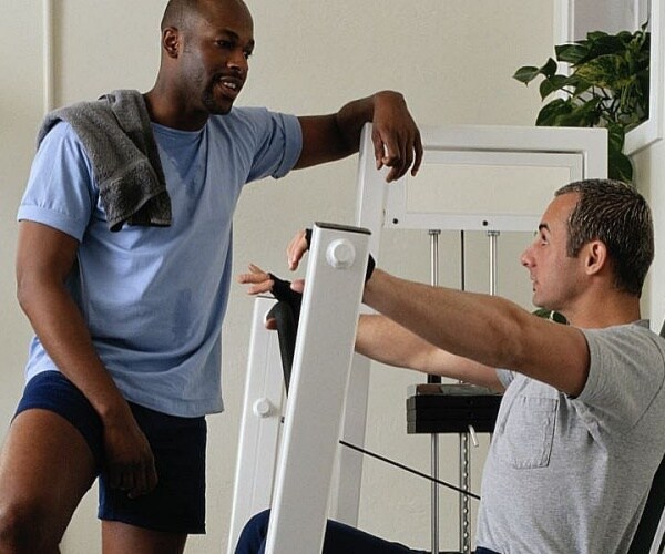 men working out on weight machines