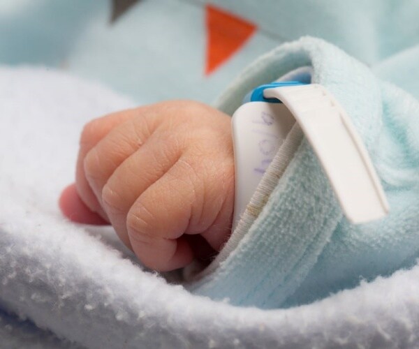 baby hand with hospital bracelet