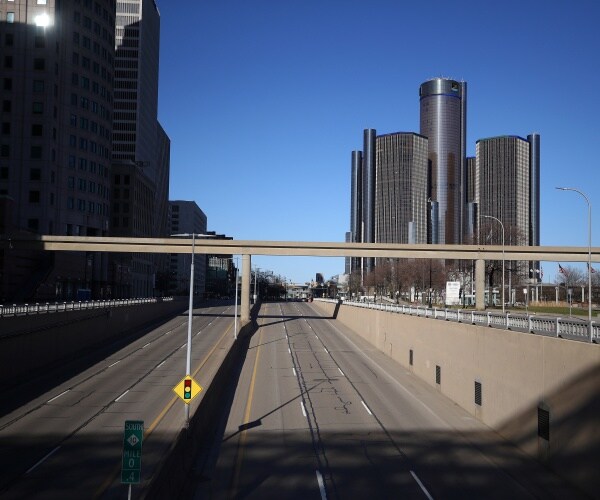 empty roads near tall buildings in downtown detroit