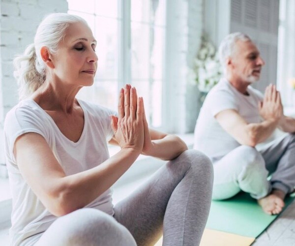 woman doing yoga in yoga class