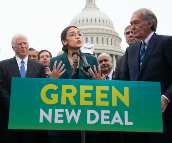 green new deal sign and lawmakers