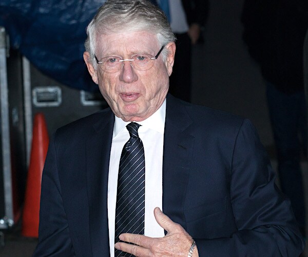 ted koppel, wearing glasses, visits with the media during a public appearance