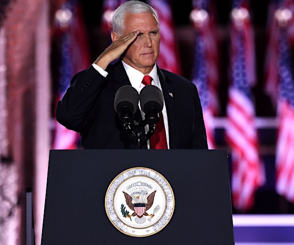 vice president mike pence gives a military salute behind a campaign podium