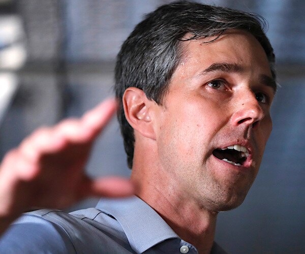 beto o'rourke gestures while speaking to the media